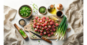 A cutting board with diced ahi tuna and chopped green onions, with bottles of sesame oil and soy sauce nearby