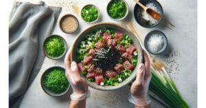 Additional green onions, sesame seeds, and seaweed salad being added to the mixing bowl with the tuna mix