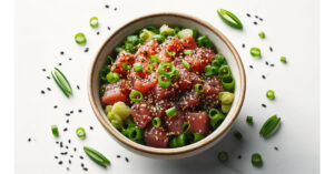 Finished Hawaiian Ahi Poke served in a white bowl, garnished with extra green onions and sesame seeds on top